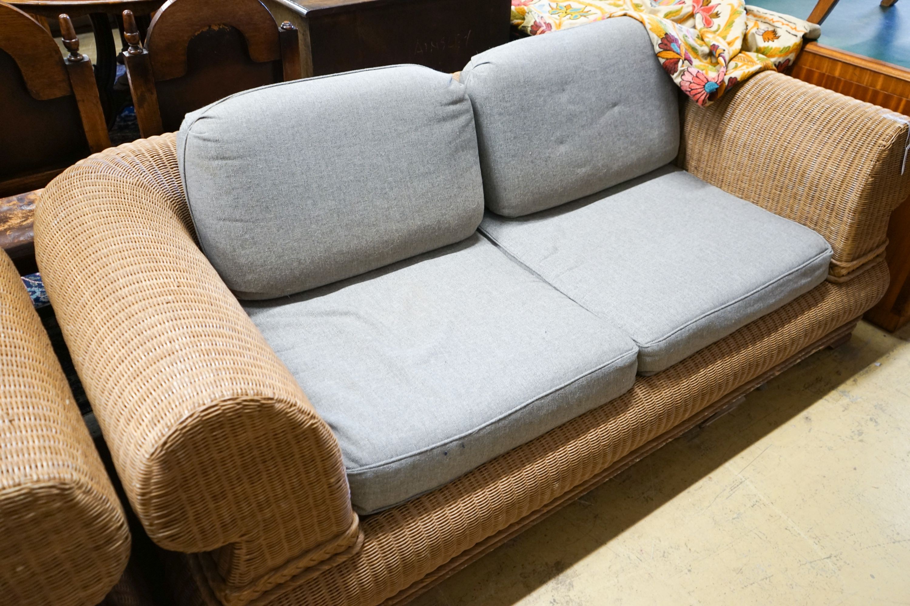 A pair of contemporary rattan conservatory settees, with grey fabric cushions, seats and backs, length 190cm, depth 100cm, height 70cm